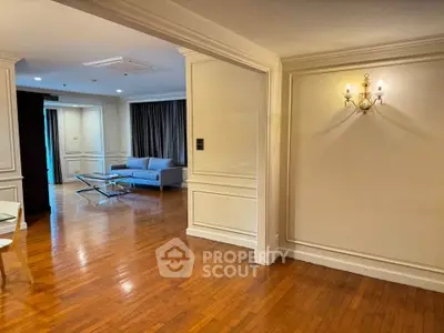 Spacious living room with elegant wooden flooring and modern lighting