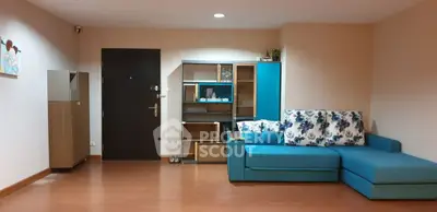 Spacious living room with modern blue sofa and stylish shelving unit