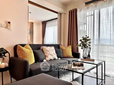 Modern living room with stylish decor and large windows offering natural light.
