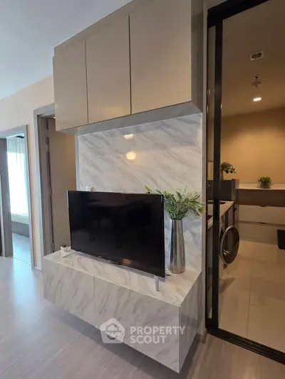 Modern living room with sleek TV setup and stylish cabinetry