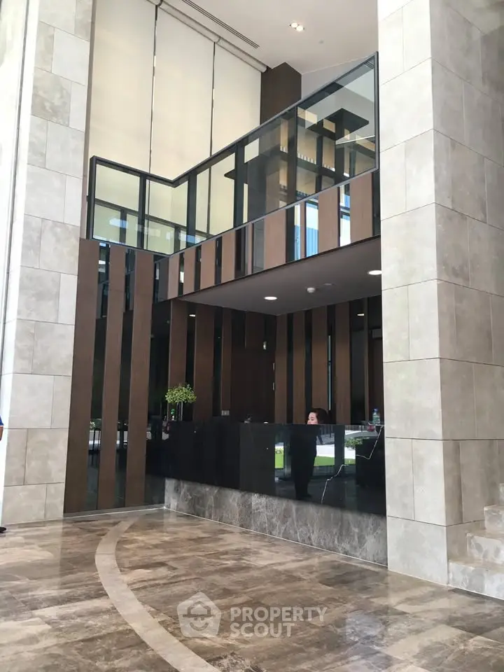 Luxurious modern building entrance with high ceilings and elegant design