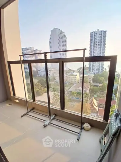 Spacious balcony with city view in modern high-rise apartment