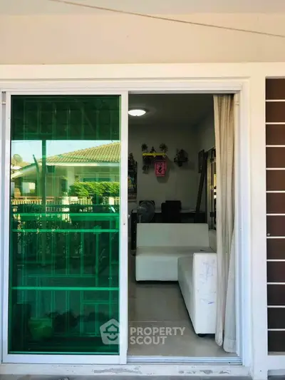 Charming home entrance with sliding glass door and cozy interior view.