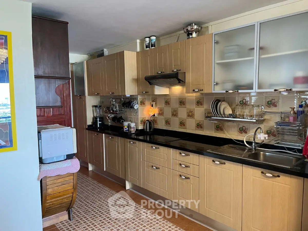 Spacious kitchen with modern appliances and ample storage in a cozy home setting.