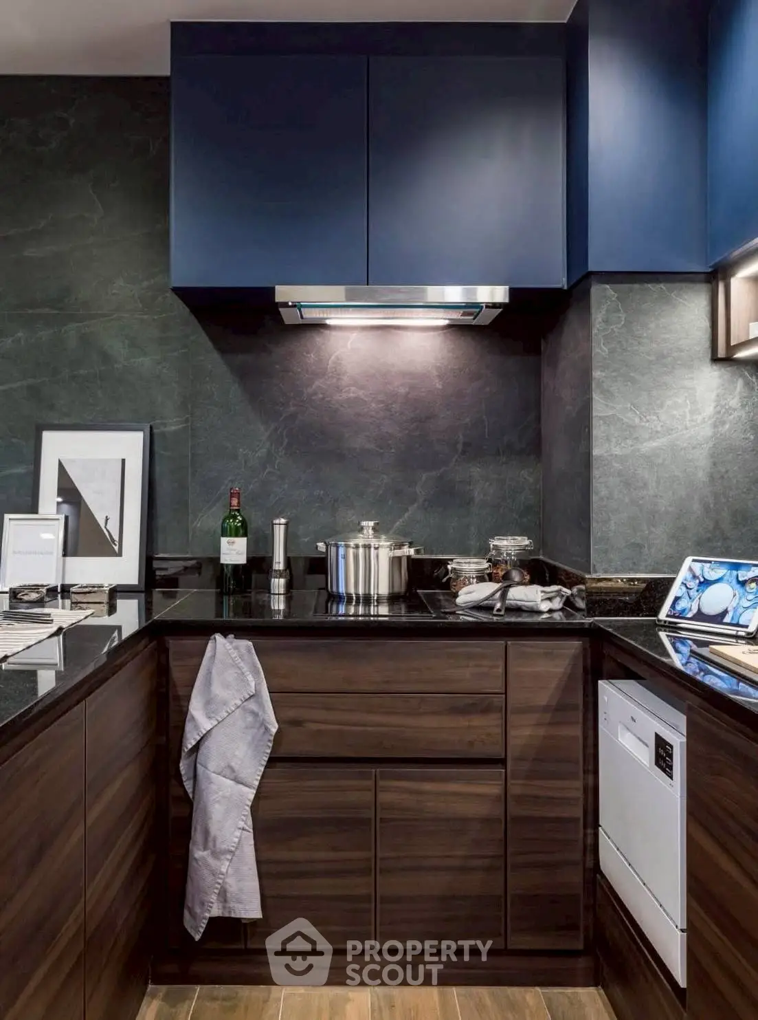 Modern kitchen with sleek dark cabinetry and built-in appliances