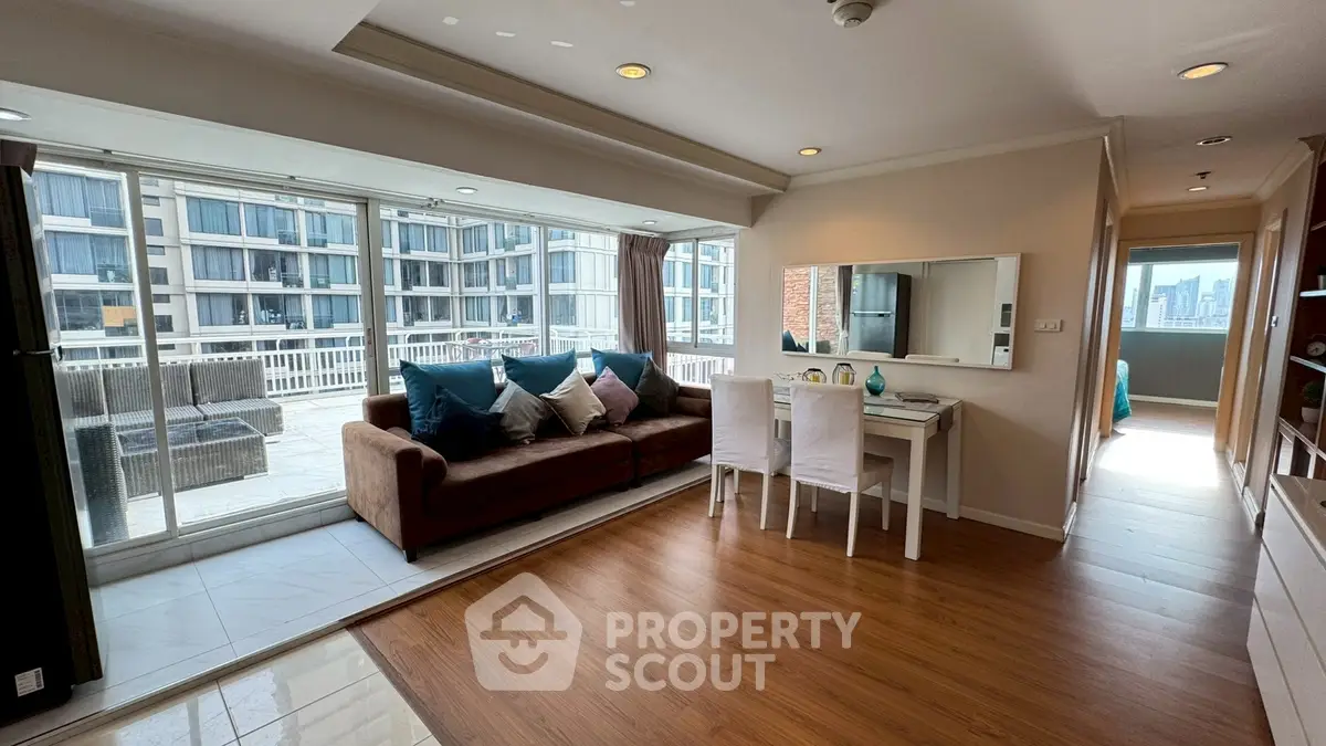 Spacious living room with large balcony and city view in modern apartment