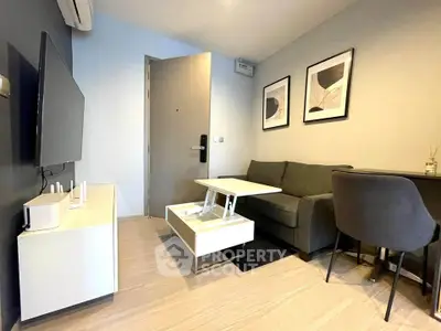 Modern living room with sleek furniture and wall art in a cozy apartment.