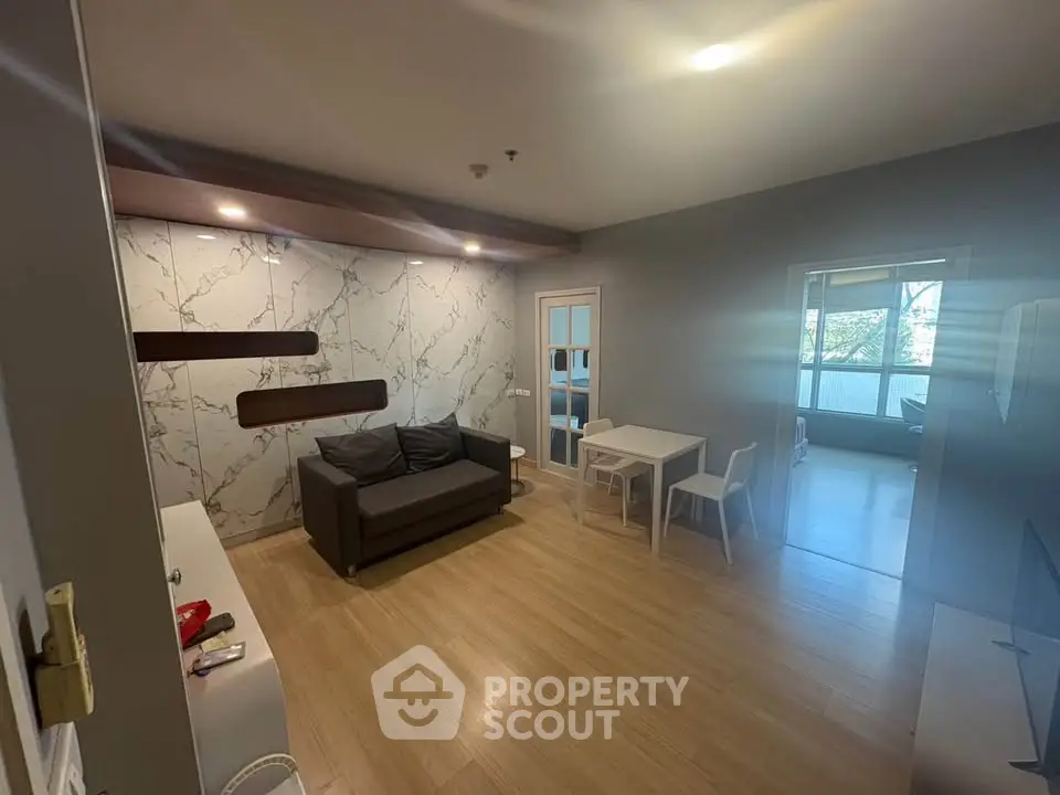 Spacious modern living room with stylish decor and ample natural light, perfect for relaxation and entertainment.