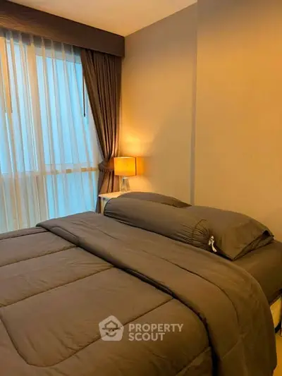 Cozy bedroom with elegant decor and soft lighting, perfect for relaxation and comfort.