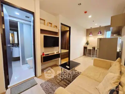 Modern living room with open kitchen and cozy decor in a stylish apartment.