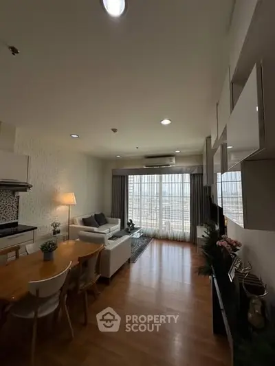 Modern living room with open layout and stylish decor, featuring a cozy seating area and dining space.
