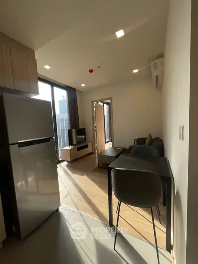 Modern living room with natural light and sleek furniture in urban apartment.