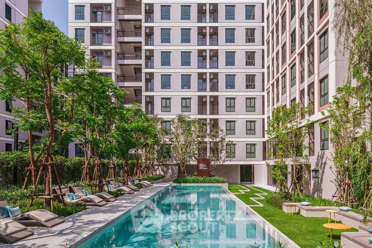 Luxurious apartment complex with a stunning outdoor pool and lush greenery, perfect for relaxation and leisure.