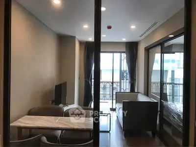 Modern living room with elegant furniture and balcony view in a stylish apartment.