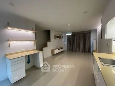 Spacious modern living area with sleek design and ample natural light.