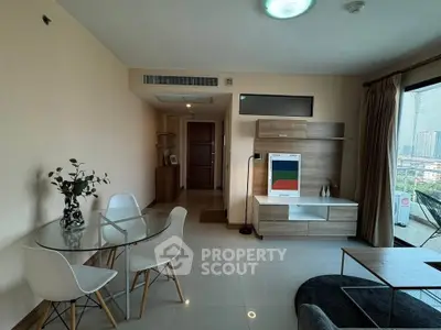 Modern living room with dining area and city view, featuring sleek furniture and natural light.