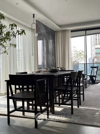Luxurious modern living room with elegant dining area and floor-to-ceiling windows offering stunning city views.