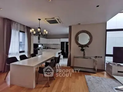 Spacious modern living room with elegant dining area and open kitchen layout.