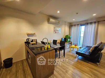Modern open-layout living room with sleek kitchen and stylish decor