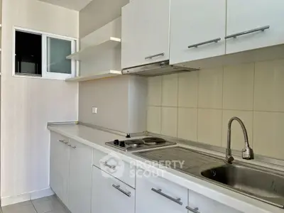 Modern kitchen with sleek cabinetry and stainless steel sink, perfect for urban living.