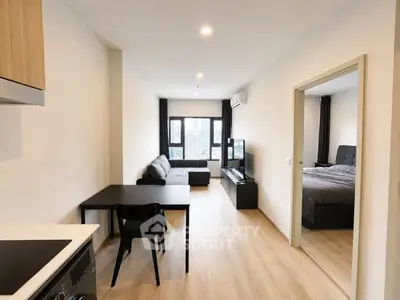 Modern open-plan living room with cozy bedroom in a stylish apartment