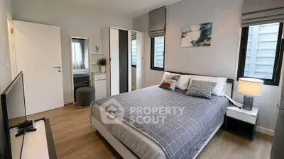 Modern bedroom with stylish decor and ample natural light