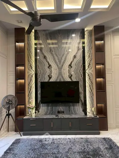 Luxurious living room with marble accent wall and modern decor