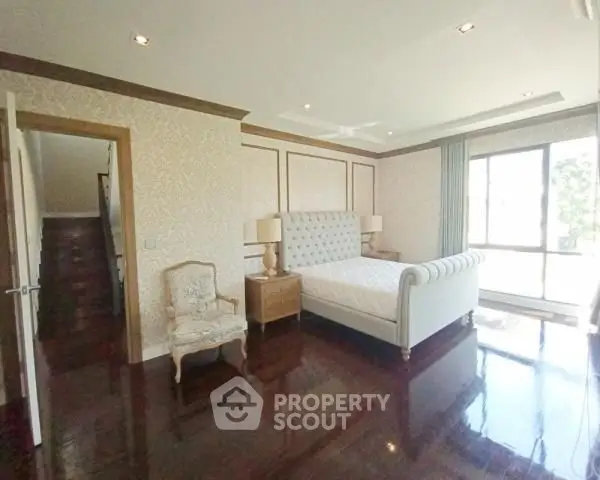 Elegant bedroom with polished wooden floors and luxurious bed