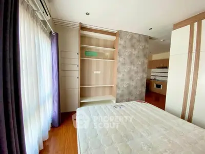 Spacious bedroom with built-in storage and natural light