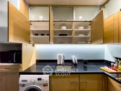Modern kitchen with open cabinets, sleek countertops, and built-in appliances for efficient living.