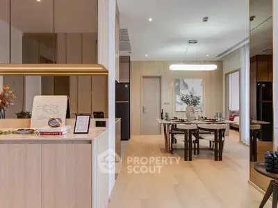 Modern open-plan living and dining area with stylish decor and elegant lighting.