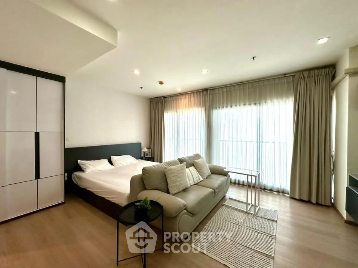 Modern studio apartment with cozy bed and stylish sofa