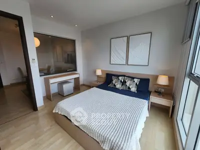 Modern bedroom with cozy decor and natural light in a stylish apartment.