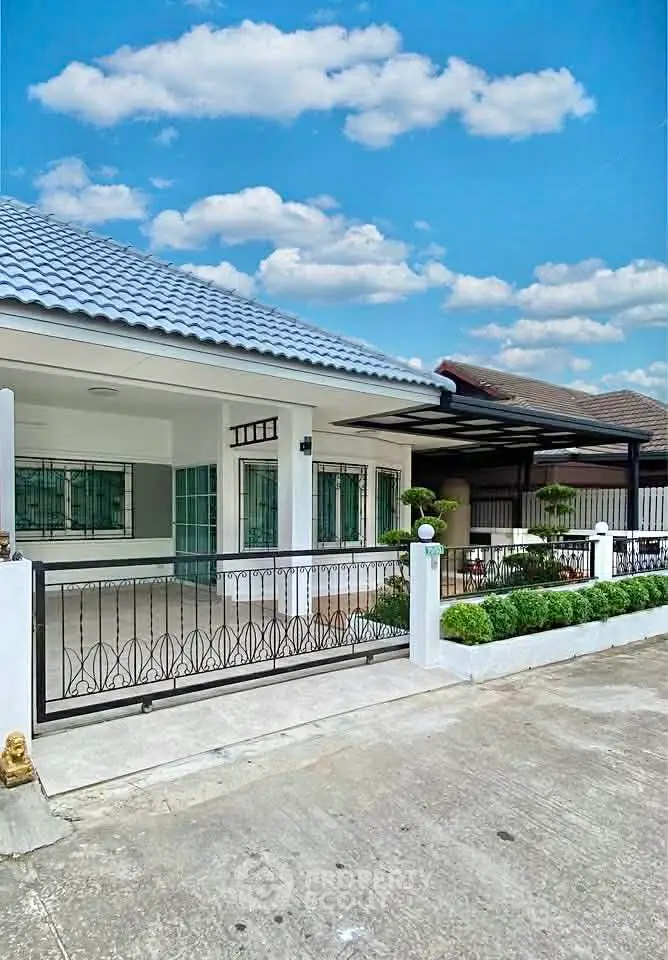 Charming single-story house with modern design and spacious driveway in a serene neighborhood.