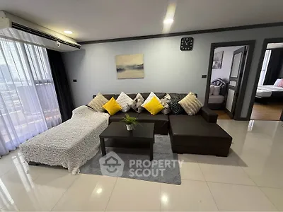 Spacious modern living room with sectional sofa and large windows
