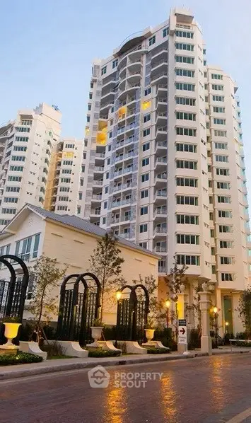 Luxurious high-rise residential building with elegant architecture and landscaped entrance