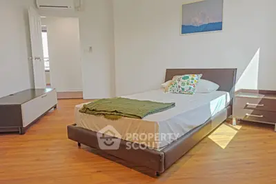 Bright and cozy bedroom with modern furnishings and wooden flooring