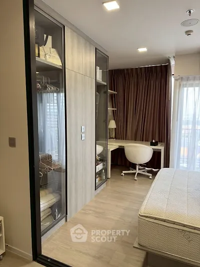 Modern bedroom with built-in wardrobe and study desk, featuring floor-to-ceiling windows and elegant curtains.