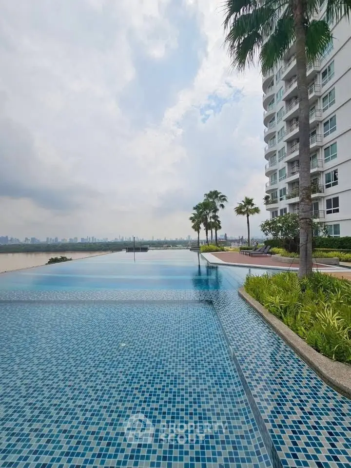 Luxurious high-rise building with stunning infinity pool and city skyline view.