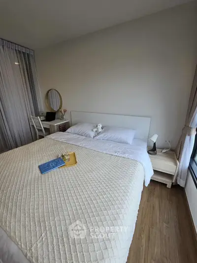 Cozy bedroom with elegant decor and natural light, featuring a comfortable bed and stylish furnishings.