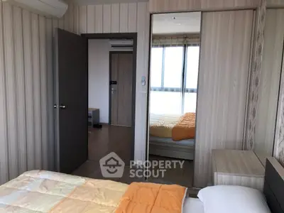 Modern bedroom with mirrored closet and air conditioning in stylish apartment.