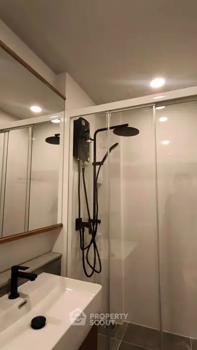 Modern bathroom with sleek shower and stylish fixtures in contemporary apartment.