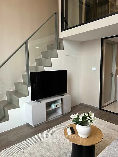 Modern duplex living room with sleek staircase and stylish decor