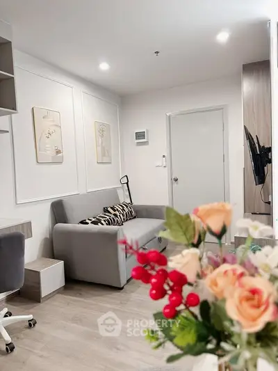 Modern living room with stylish decor and cozy gray sofa, perfect for relaxation and entertainment.