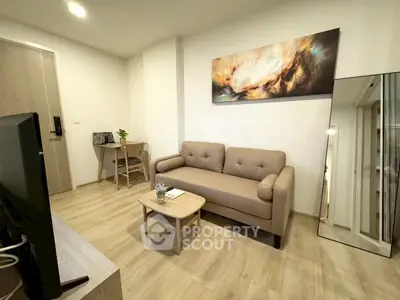 Modern living room with beige sofa, stylish decor, and wooden flooring