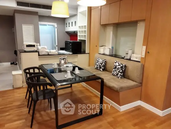 Modern dining area with stylish table and chairs, cozy seating, and sleek kitchen backdrop.