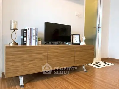 Modern living room with sleek wooden TV stand and stylish decor