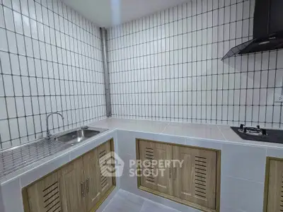 Modern kitchen with sleek gas stove and stylish cabinetry in a contemporary home.