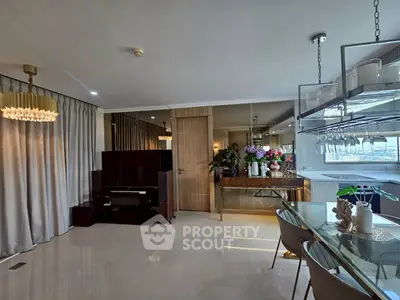 Luxurious open-plan living and dining area with modern decor and elegant lighting.