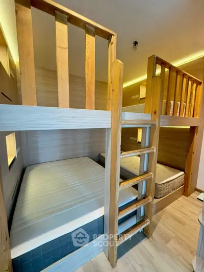Modern bunk bed setup in a cozy wooden-themed bedroom with ambient lighting.